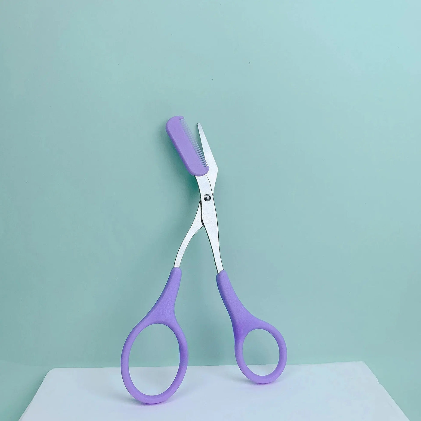 Pink eyebrow trimming scissors with built-in comb - stainless steel, precise grooming tool, creating perfect eyebrows Makeup art