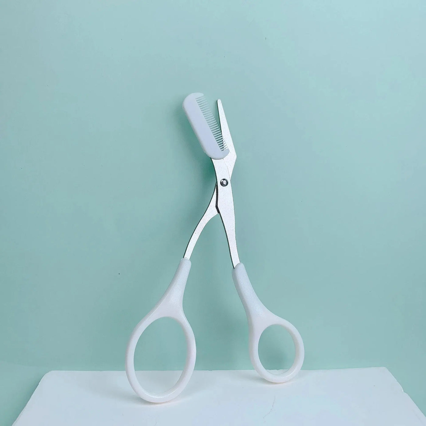 Pink eyebrow trimming scissors with built-in comb - stainless steel, precise grooming tool, creating perfect eyebrows Makeup art