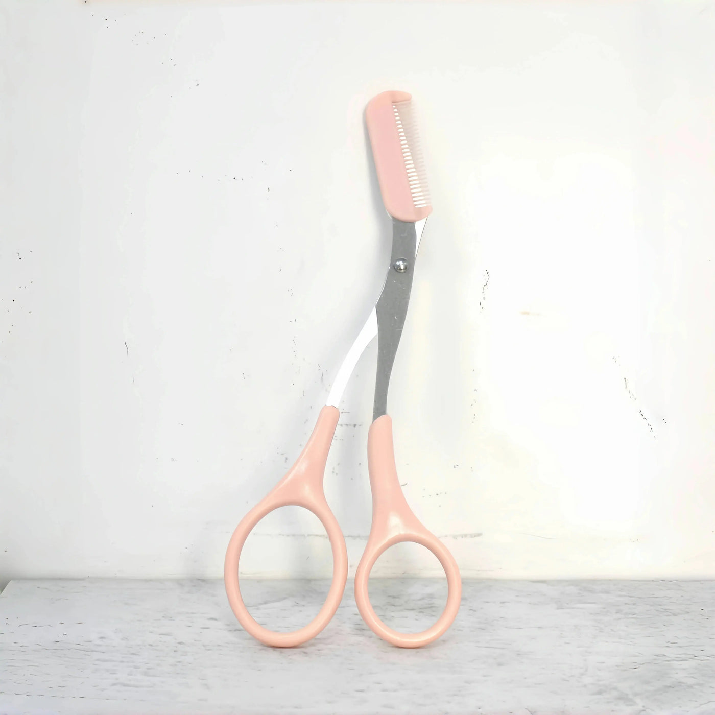 Pink eyebrow trimming scissors with built-in comb - stainless steel, precise grooming tool, creating perfect eyebrows Makeup art