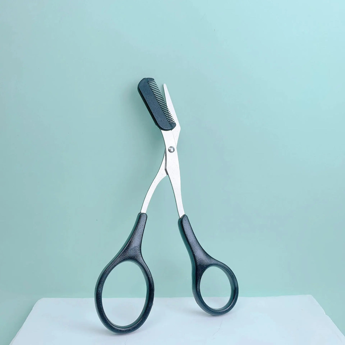 Pink eyebrow trimming scissors with built-in comb - stainless steel, precise grooming tool, creating perfect eyebrows Makeup art