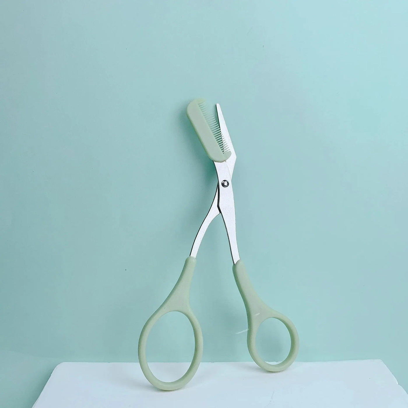 Pink eyebrow trimming scissors with built-in comb - stainless steel, precise grooming tool, creating perfect eyebrows Makeup art